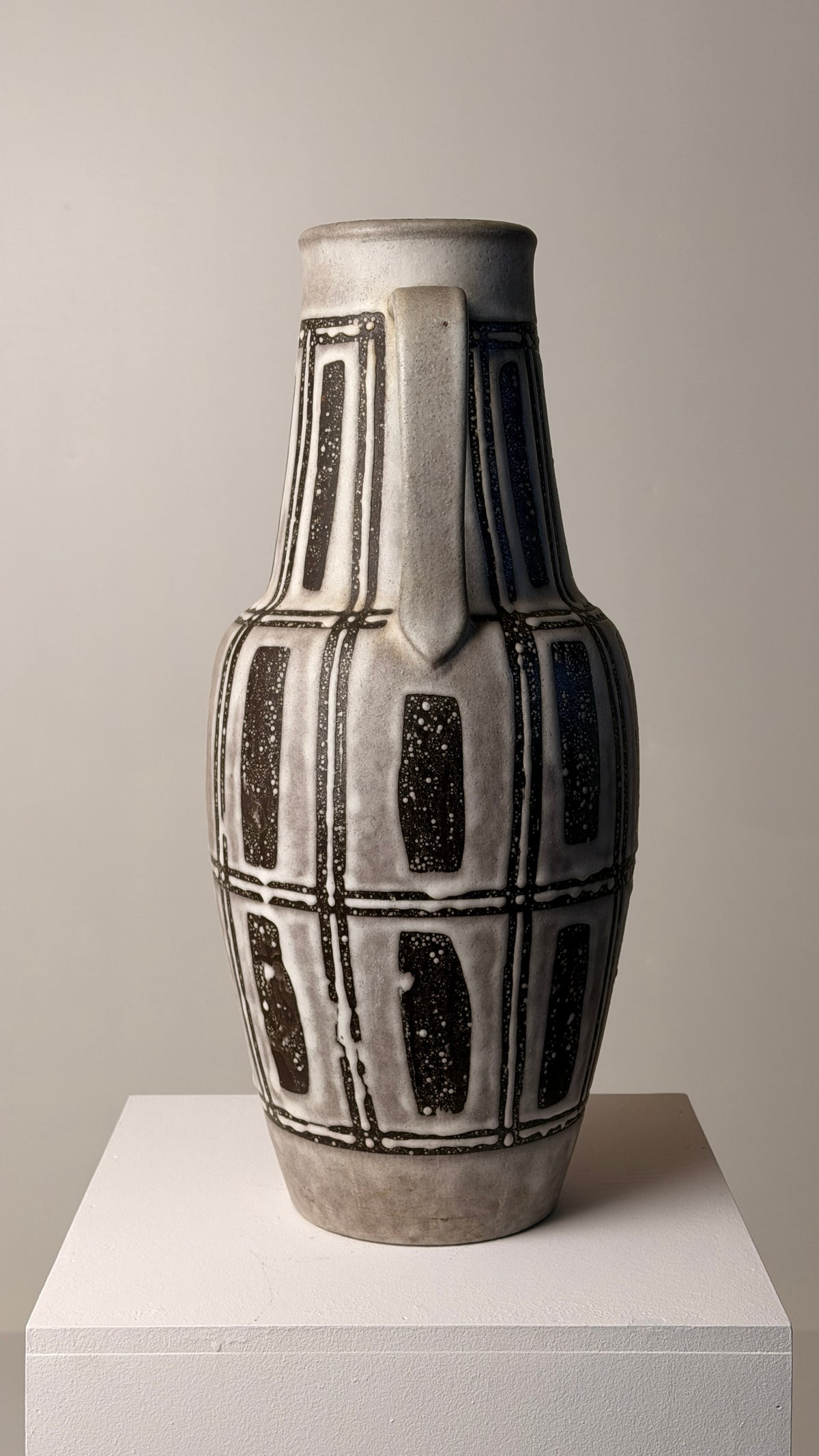 Ceramic pitcher, Germany, circa 1960 — side view on white pedestal
