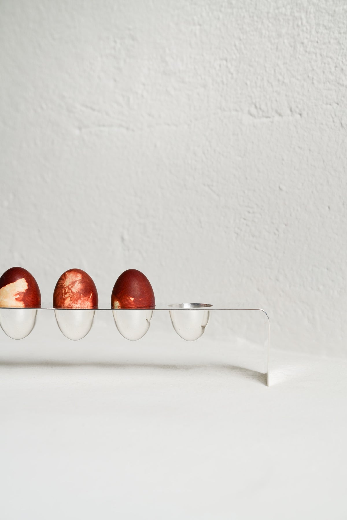 Minimalist Silver Tableware — side view of eggs on silver holder