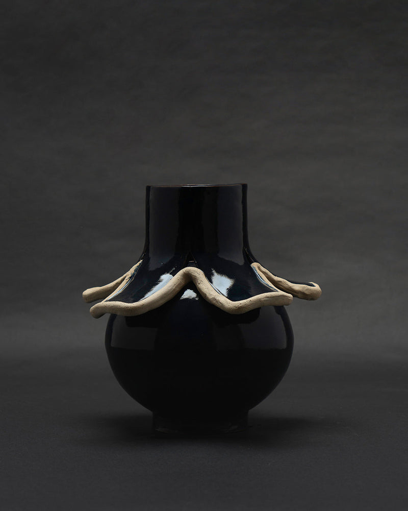 Navy blue glazed ceramic vase with undulating raw clay collar