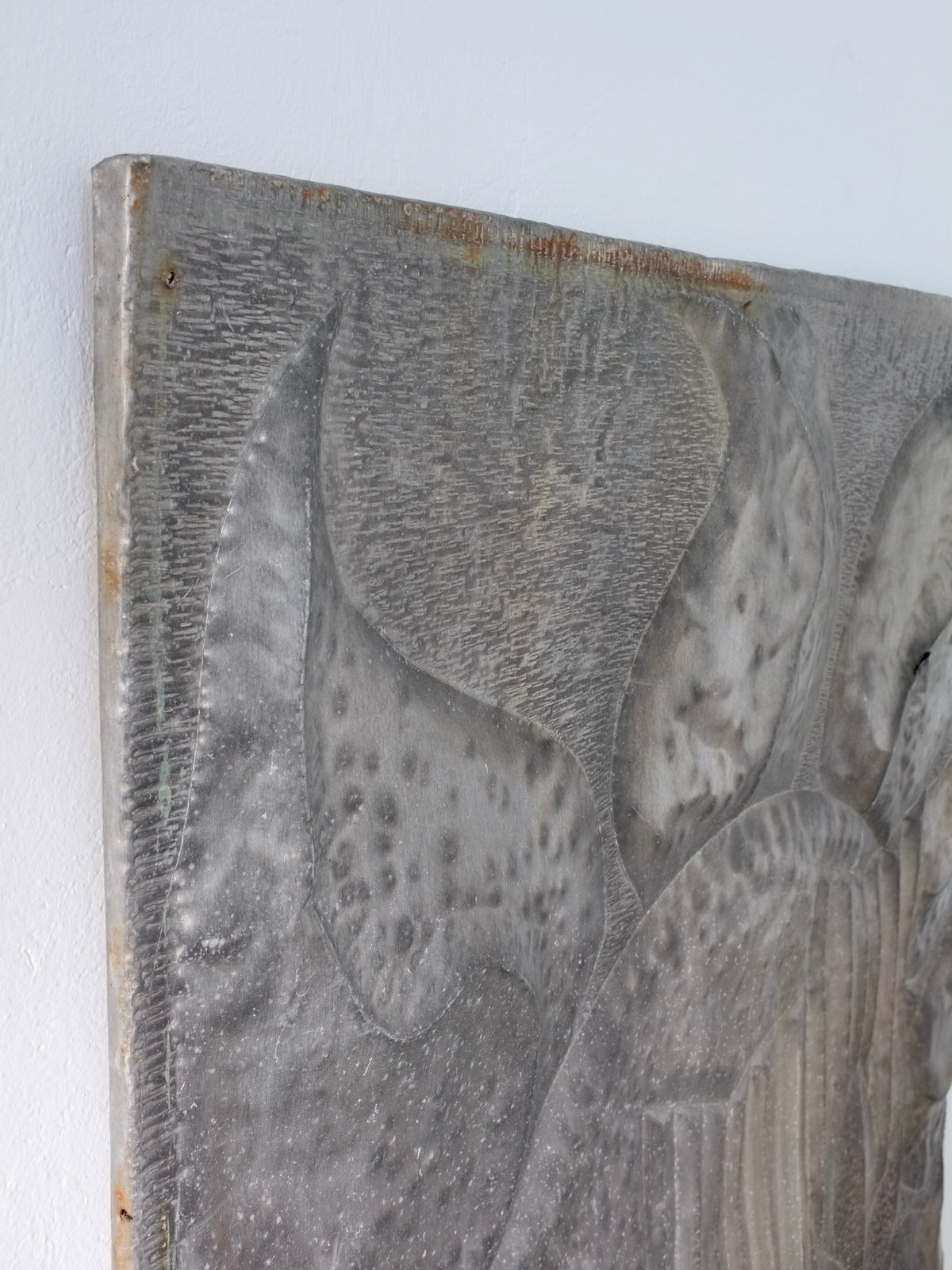 Textured metal surface detail of Brutalist relief sculpture