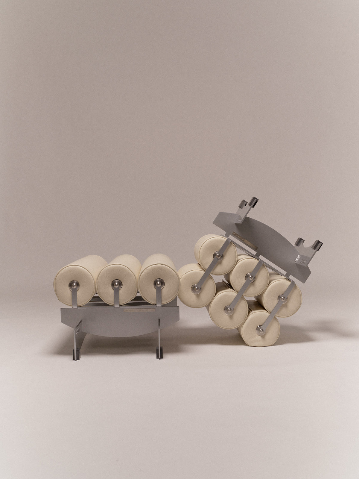 Ottoman Bassa — angled view of gray frame with cream cushions