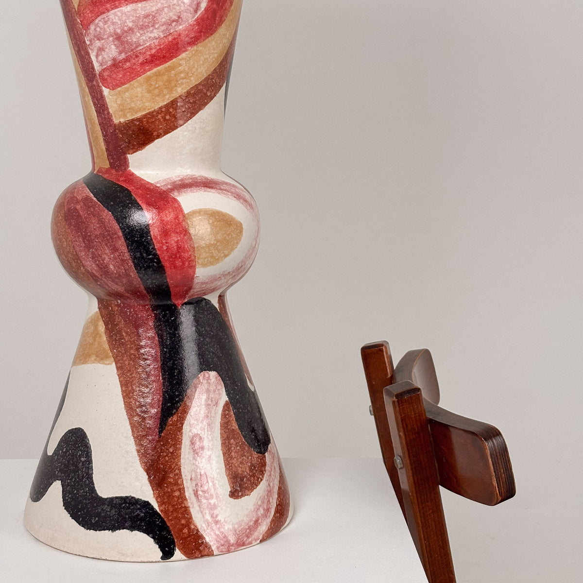 Large ceramic table lamp base detail showing abstract painted motifs in red, black and beige, 1960s