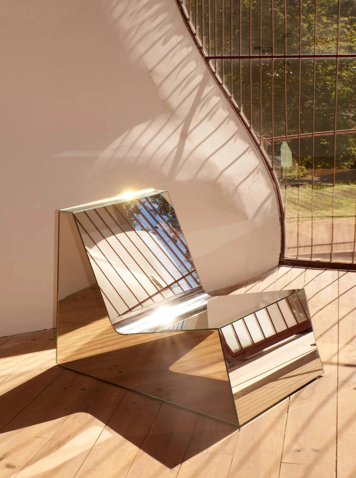 Mirror Lounge Chair — top view of mirrored surface and wooden base