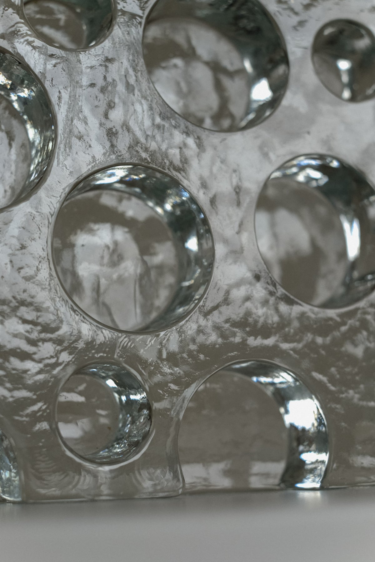 Glass Candle Holder — close-up of textured glass surface with circular cutouts