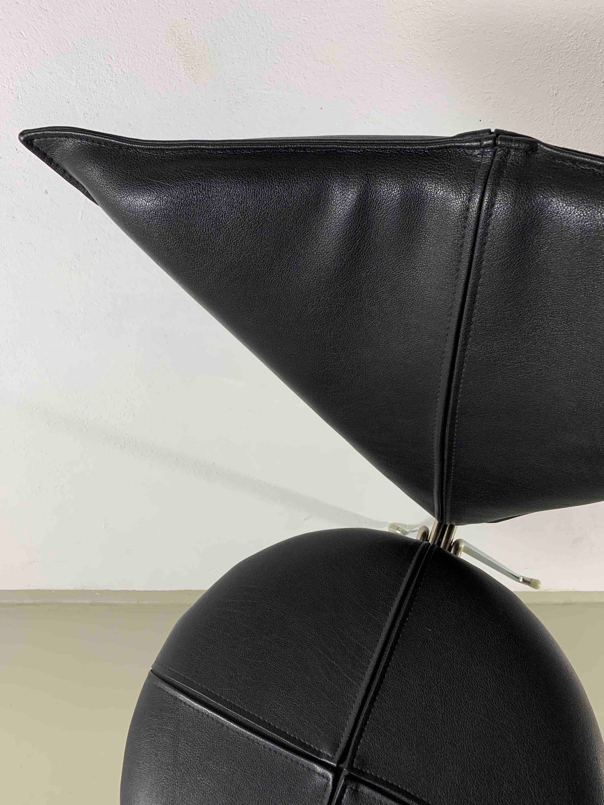 Close-up detail of black leatherette upholstery on Lubke chair