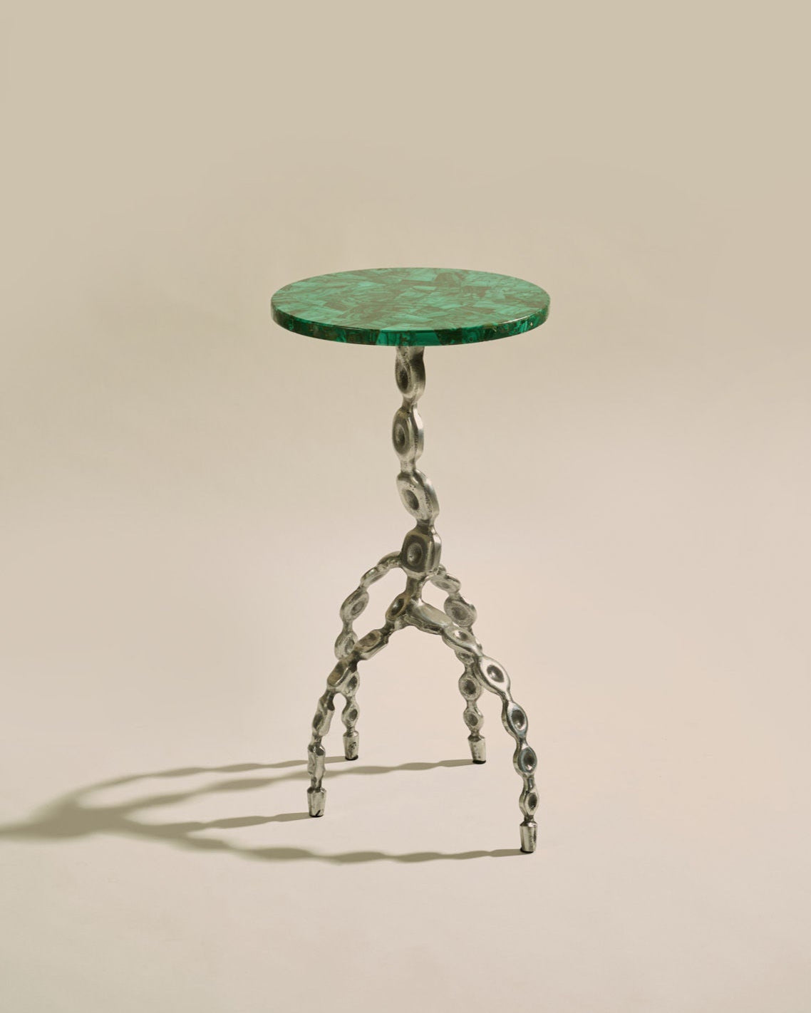 Aetheris Table — top view of green marble surface and metal legs