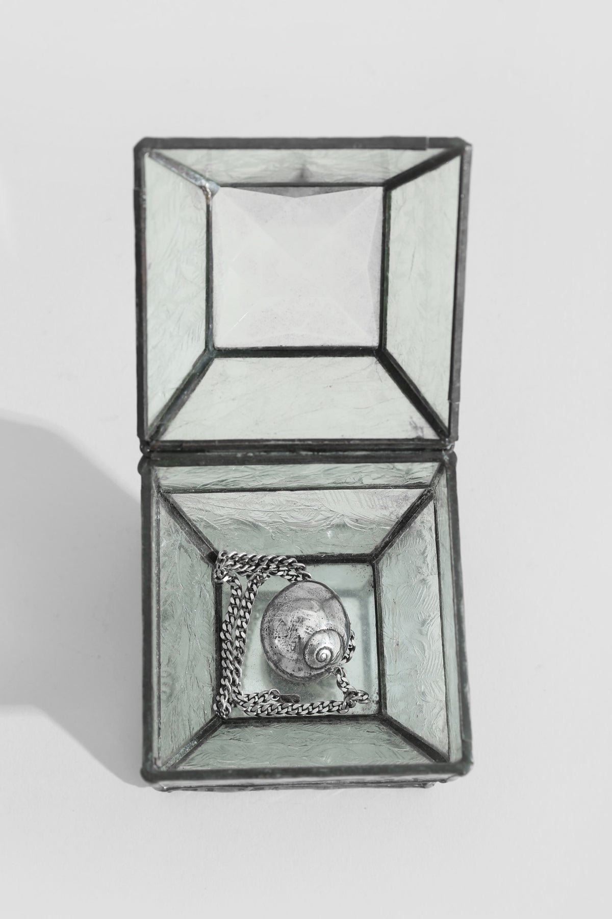 Faceted Glass Jewelry Box — top view with silver necklace inside
