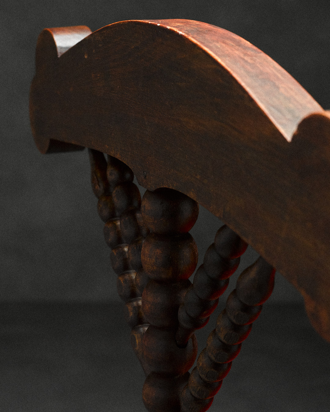 triangular bobbin chair — close-up of dark wood detailing