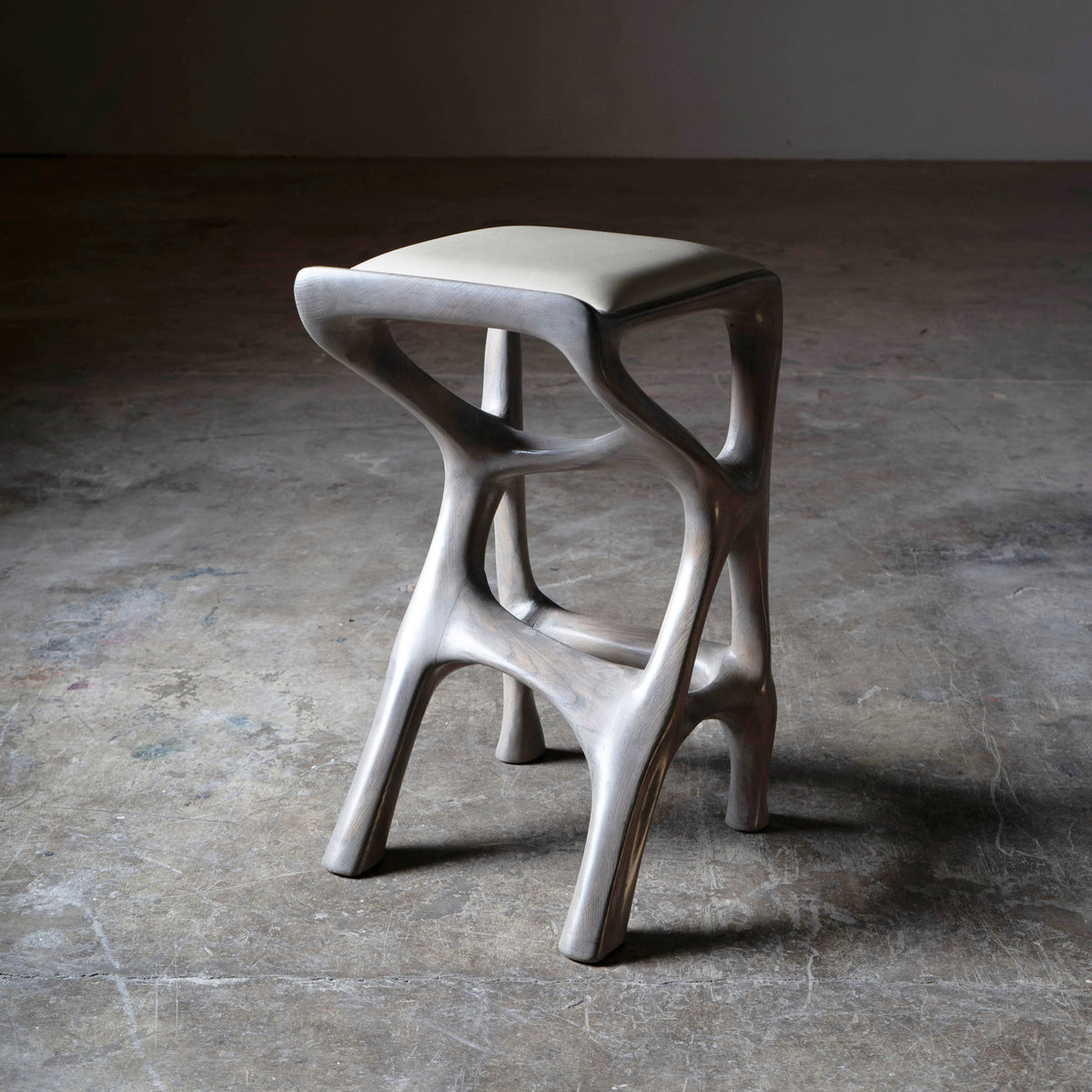 Sculptural Chimera Stool in Ash Wood with Upholstery — side angle