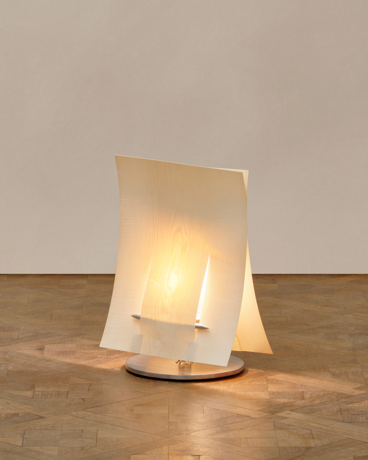 Modern translucent table lamp with curved folded shade on wood base