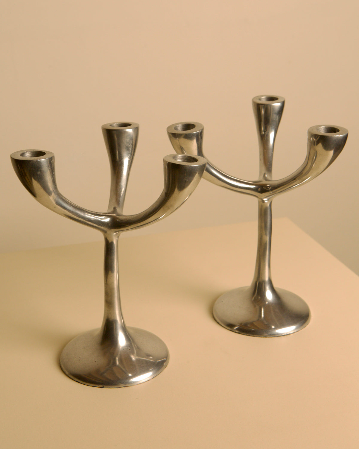 Pair of Italian "Tree" candlesticks from the 70s — side angle showing polished metal finish