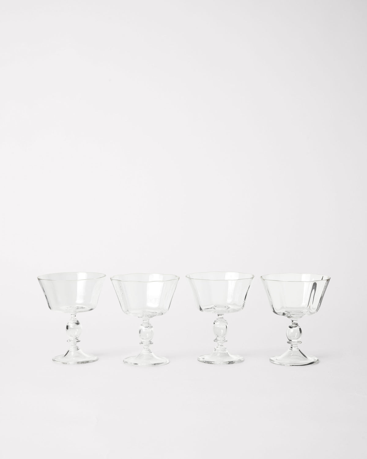Alban Champagne Glass - Set of Four — arranged in a row on white background