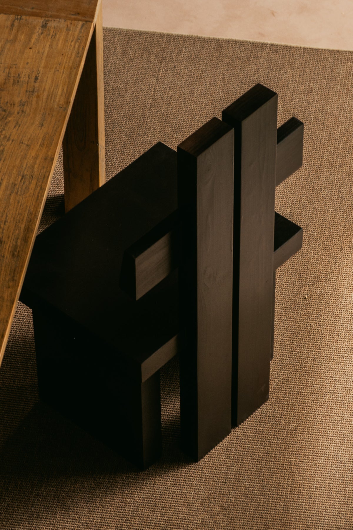 CH02 CHAIR — top view of black wooden chair on textured rug