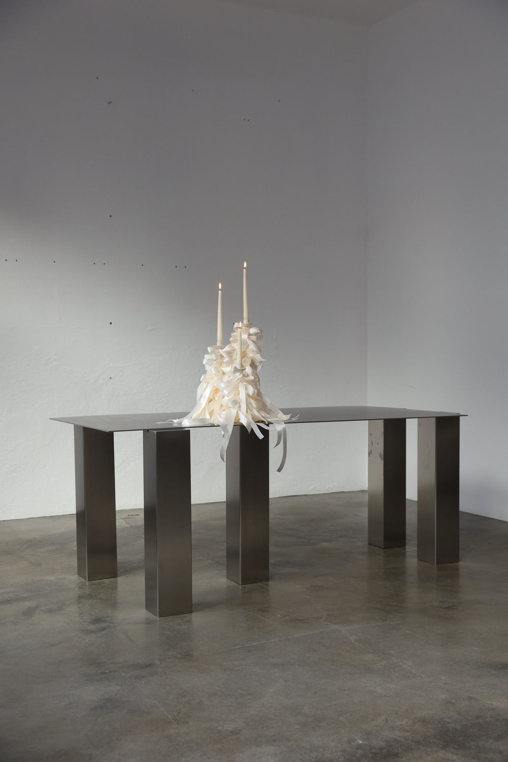 Atrium Desk — close-up of polished metal surface with candles