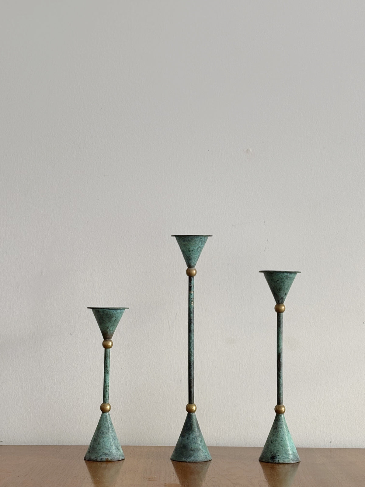 Set of 3 Postmodern Candleholders — side angle showing patinated metal finish