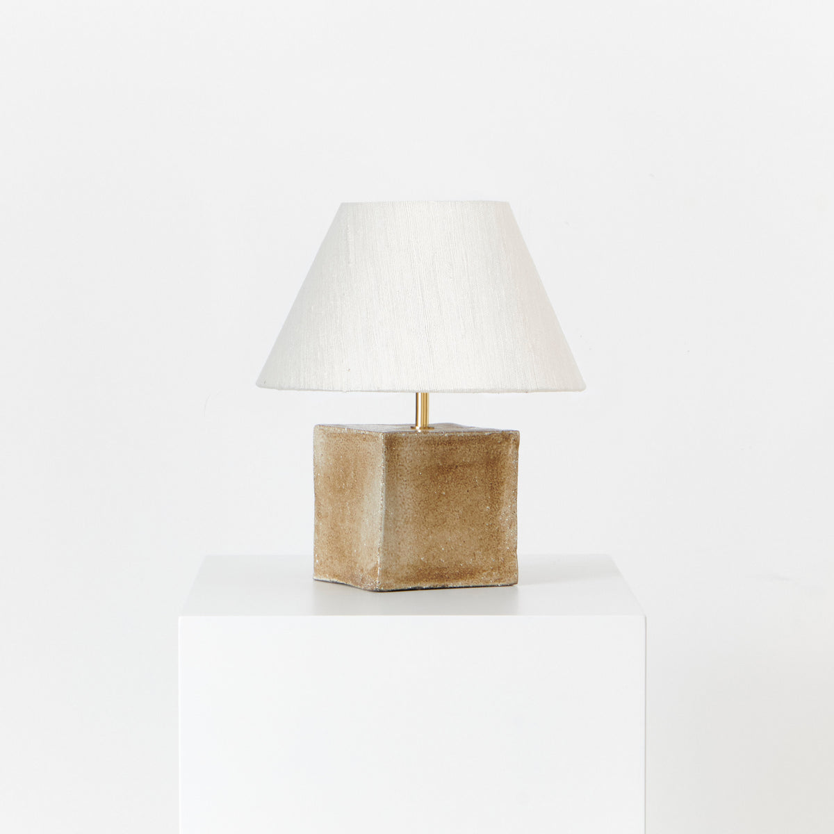 Arouca Table Light Brown Sugar — angled view on white pedestal