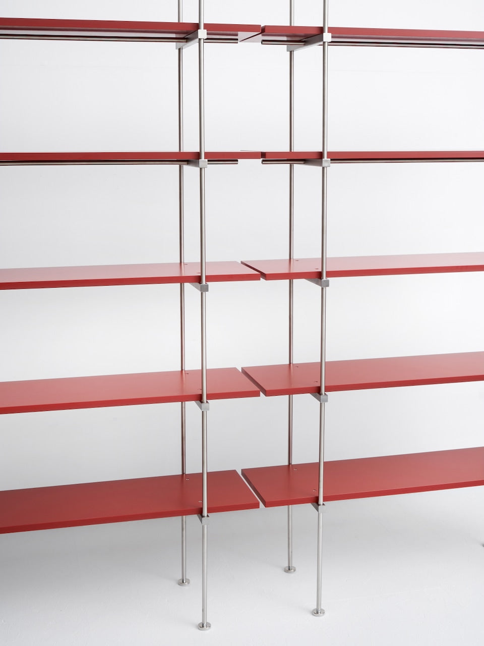 Spaghetti Shelf System — angled view of red metal shelves