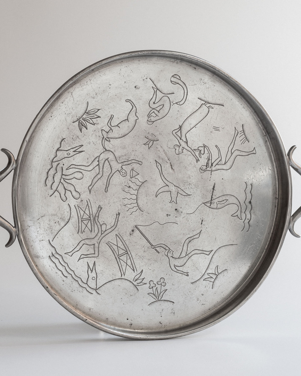 Art Deco pewter tray detail showing engraved aquatic motifs
