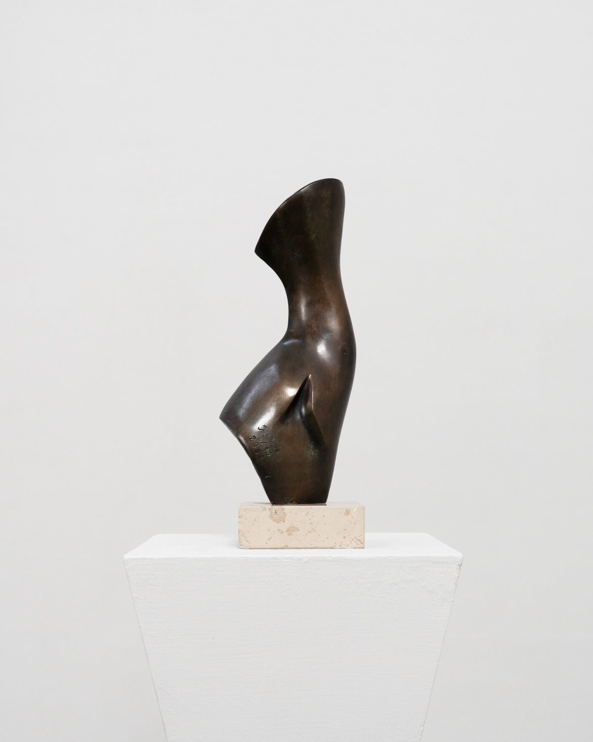 Abstract bronze sculpture with curved flowing form on marble base by Stanislaw Wysocki