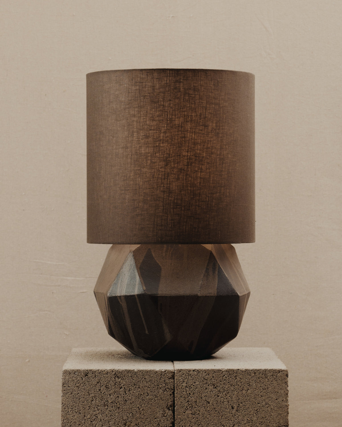 Geode Lamp — front view on textured stone pedestal