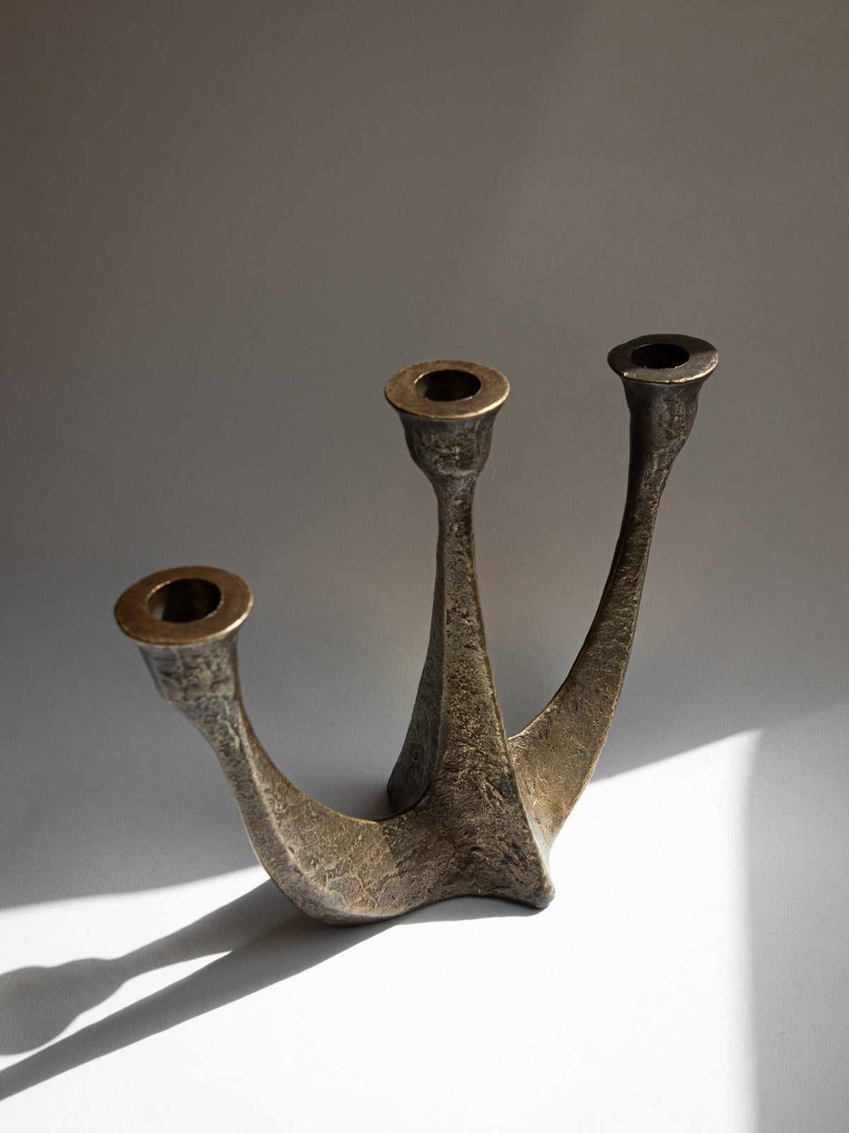 Textured bronze brutalist candelabra, three-arm detail, 1970s Germany