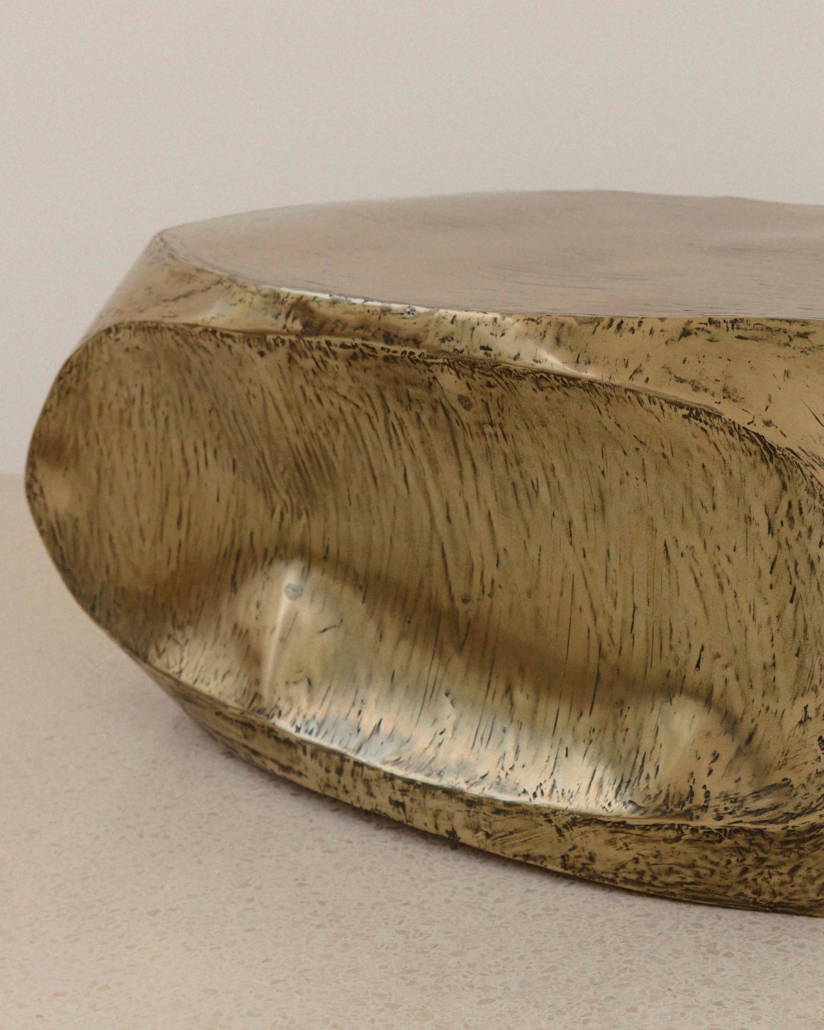 Close-up detail of brass resin texture on ROCHER coffee table