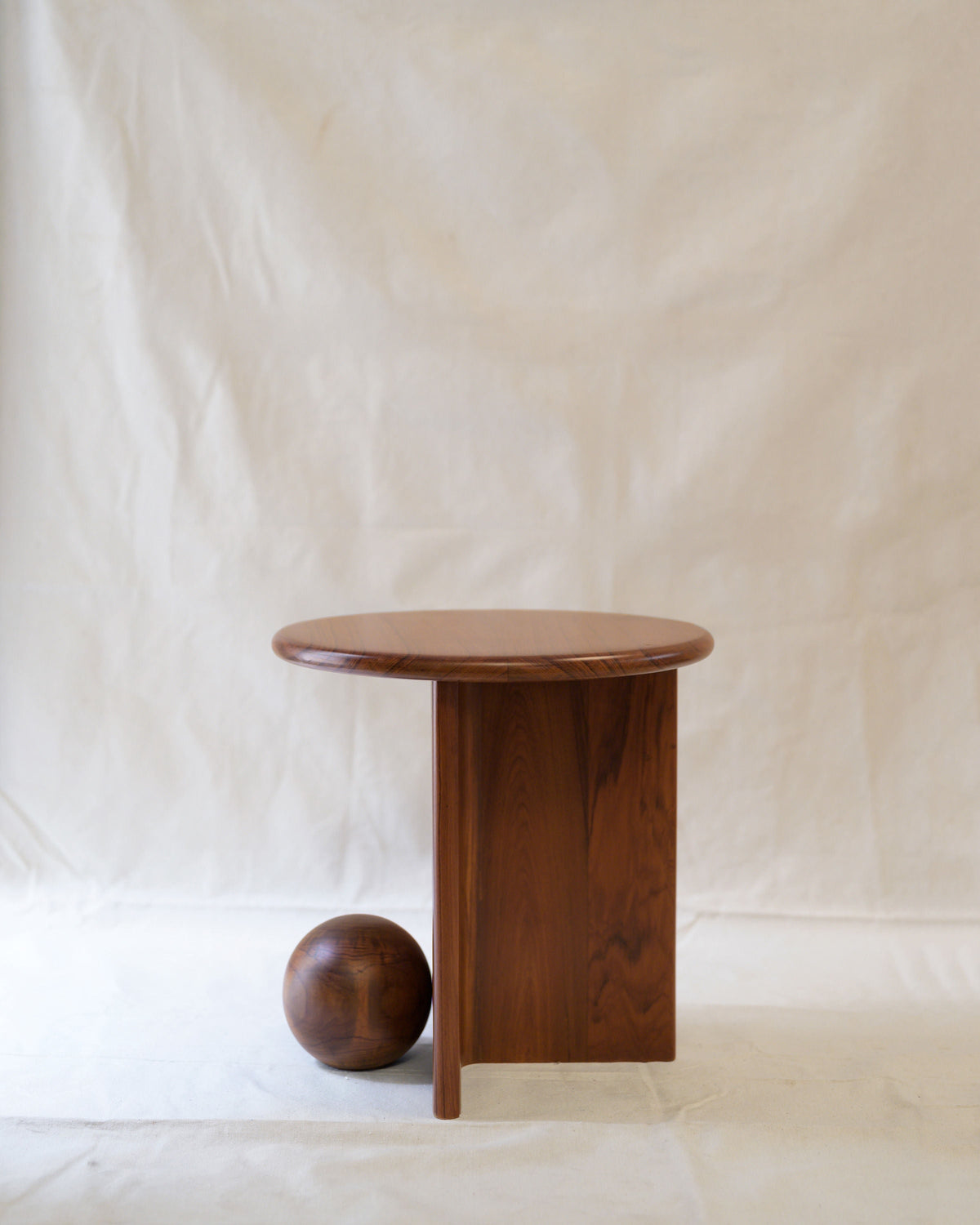 Dory walnut side table with cylindrical base and spherical accent