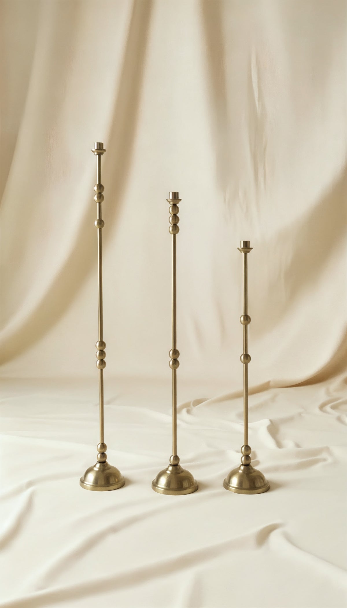 ASHA I – Brushed Brass Sculptural Candlestick Set — detail of brushed brass texture