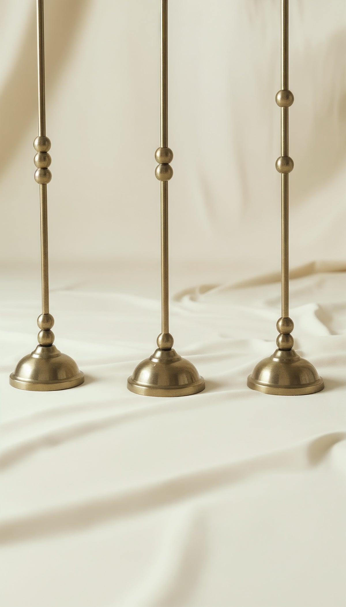 ASHA I – Brushed Brass Sculptural Candlestick Set — side angle showing brushed brass bases