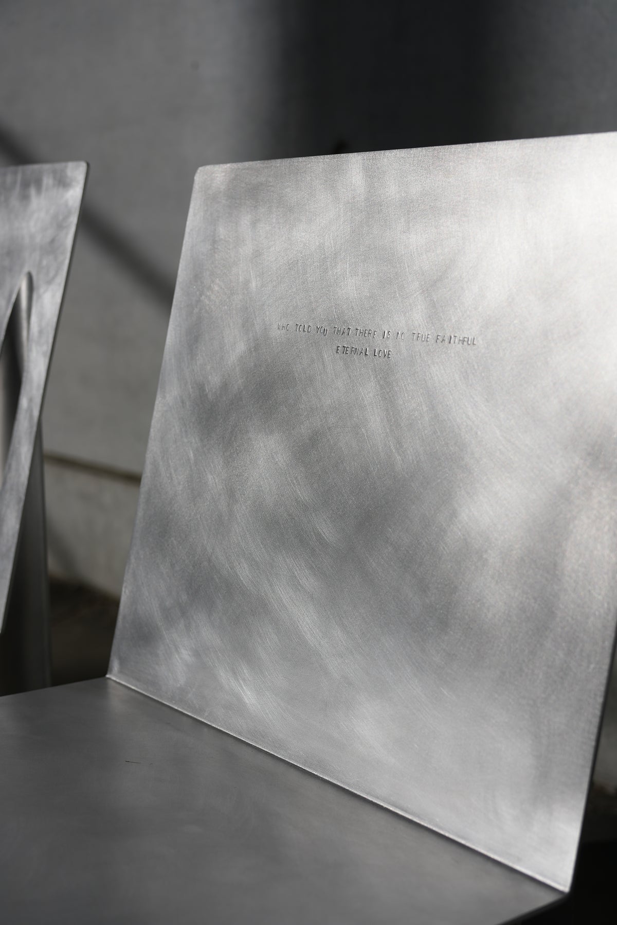 MASTER & MARGARITA — close-up of brushed metal backrest in natural light
