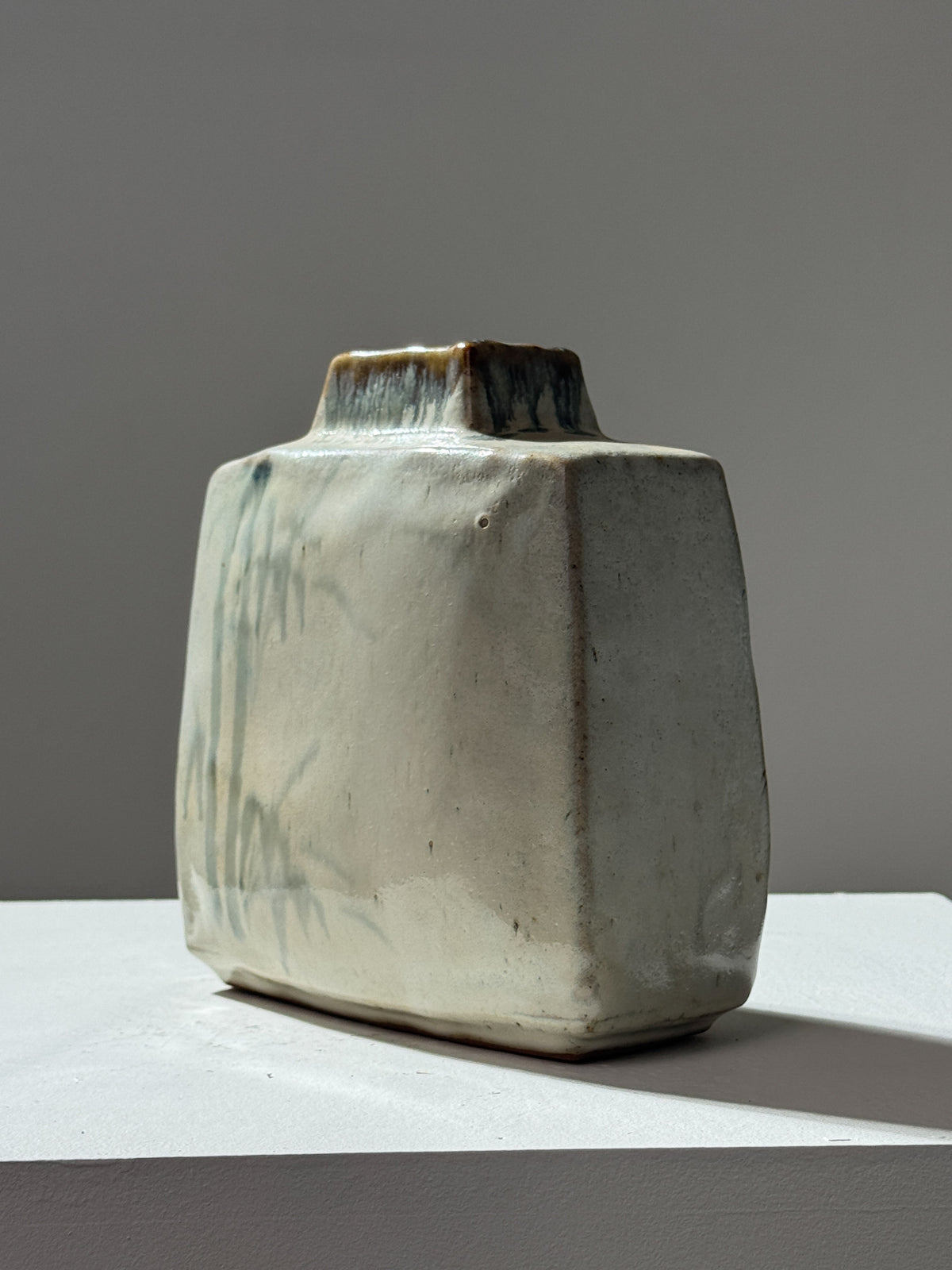 Angular ceramic vase with organic drip glaze in sage green tones