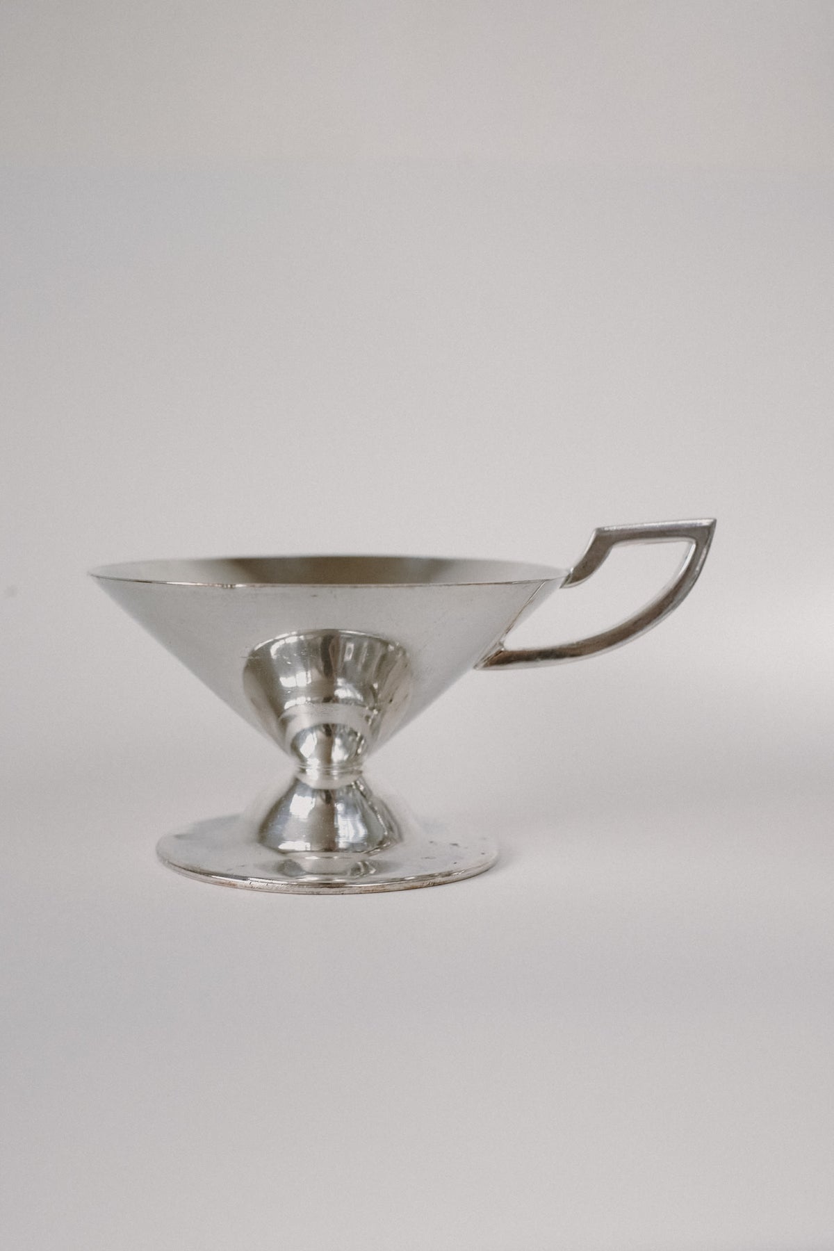 Set of Serving Cups in Silver — side view on neutral background