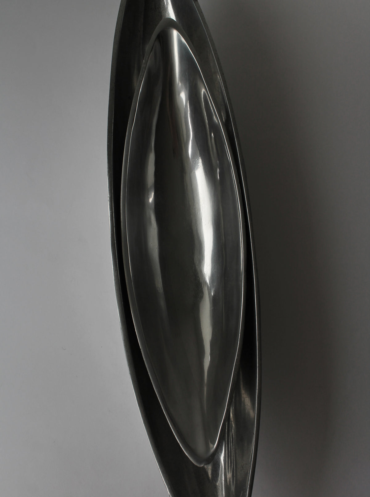 Polished aluminum bowl profile view showing curved reflective surface