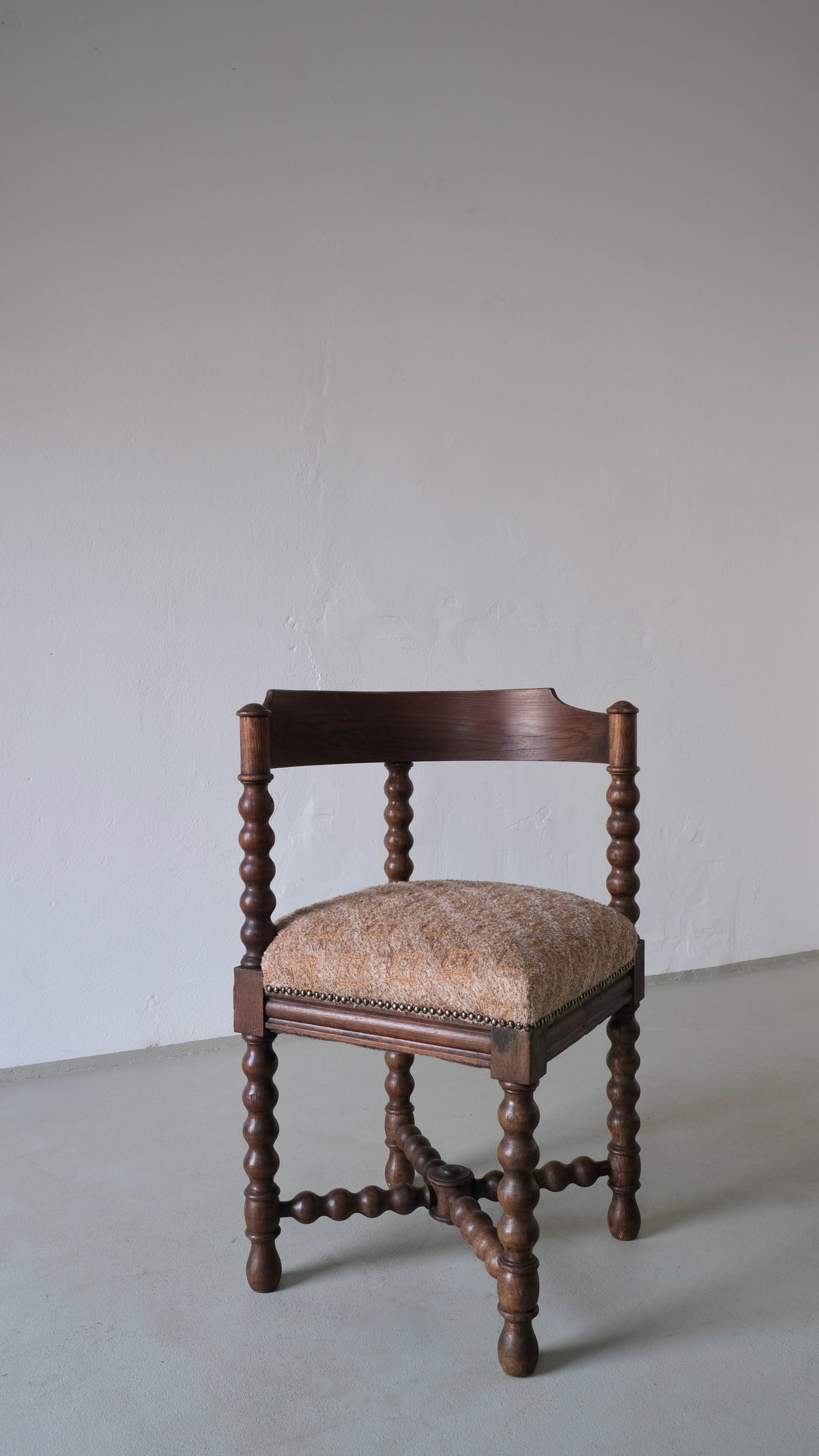 Antique bobbin turned corner chair with upholstered seat detail