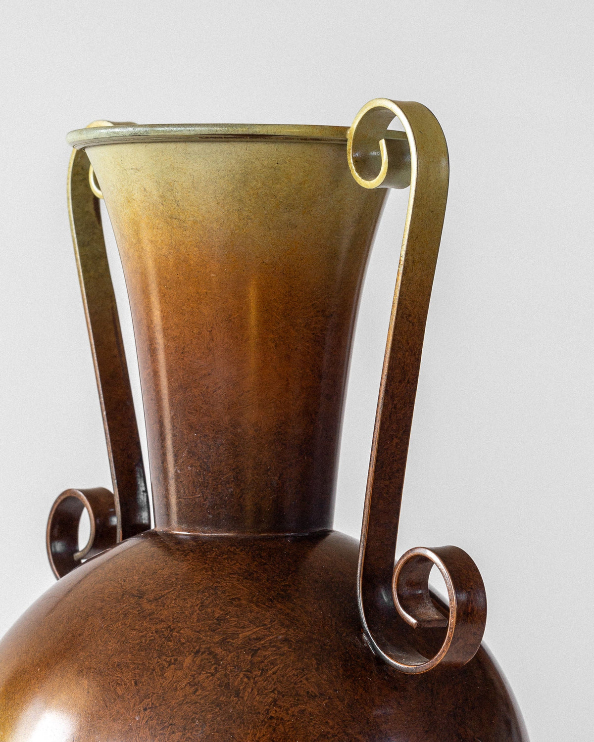 A close-up of the Spigel Swedish Art Deco Bronze Vase, featuring a wide neck and ornate curled handles, beautifully displayed against a plain white background.