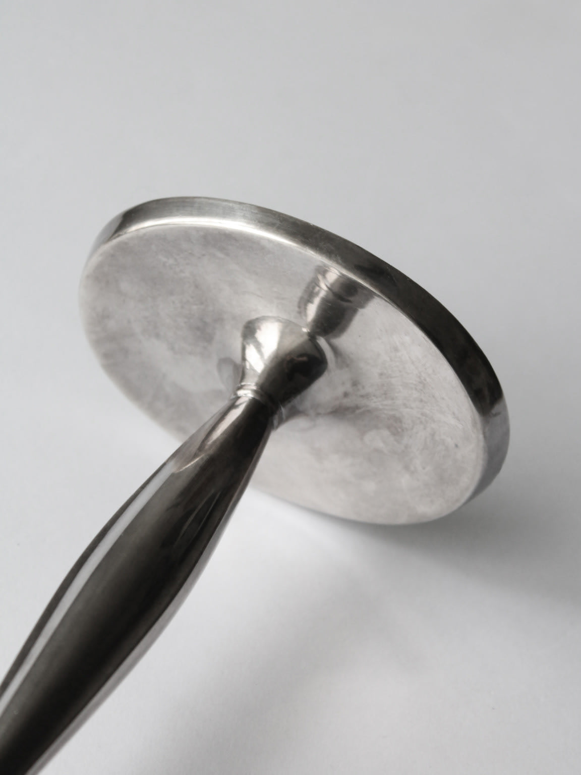 Close-up detail of silver plated candlestick handle and base