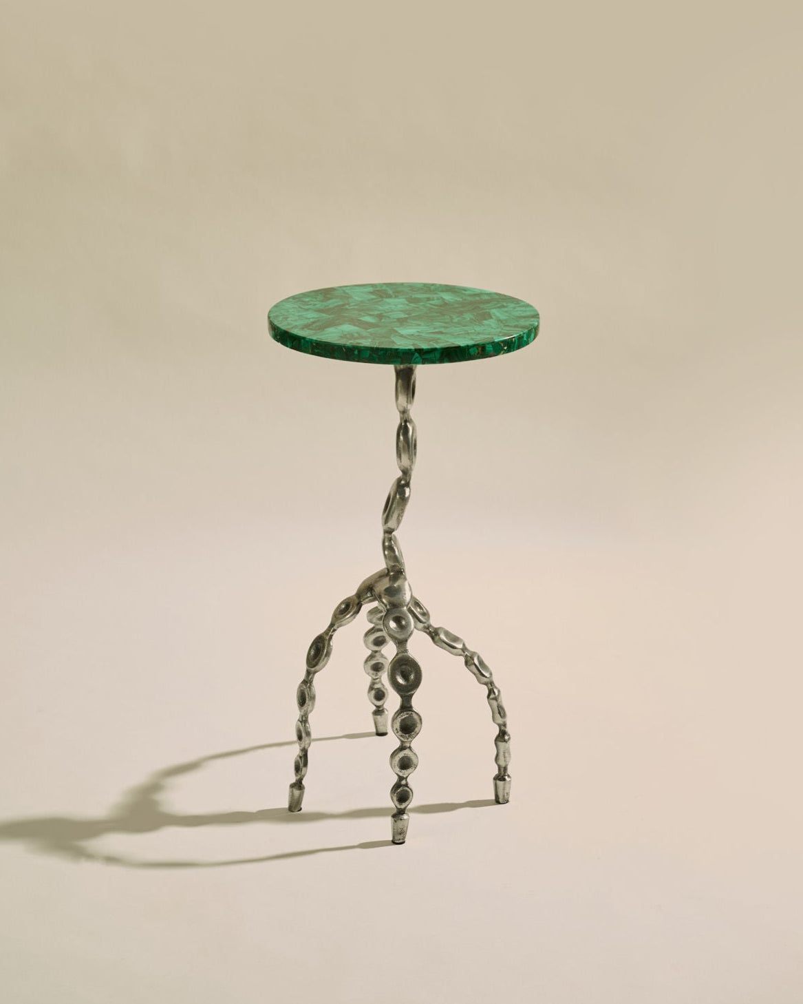 Aetheris Table — side view of green marble top and metal base