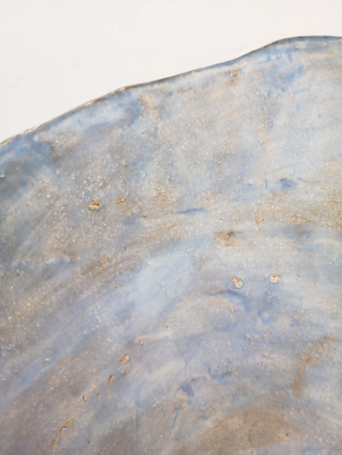 Coupe 22 — side angle showing textured blue ceramic surface