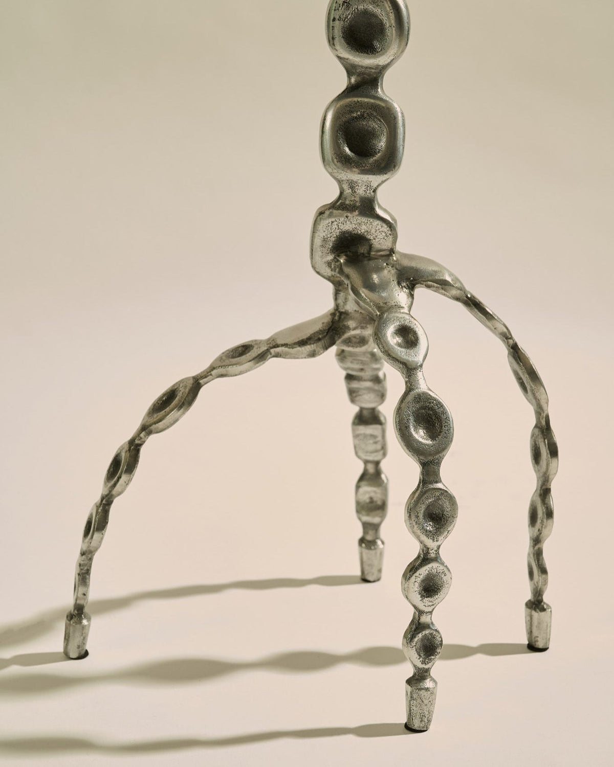 Aetheris Table — back view of textured metal legs