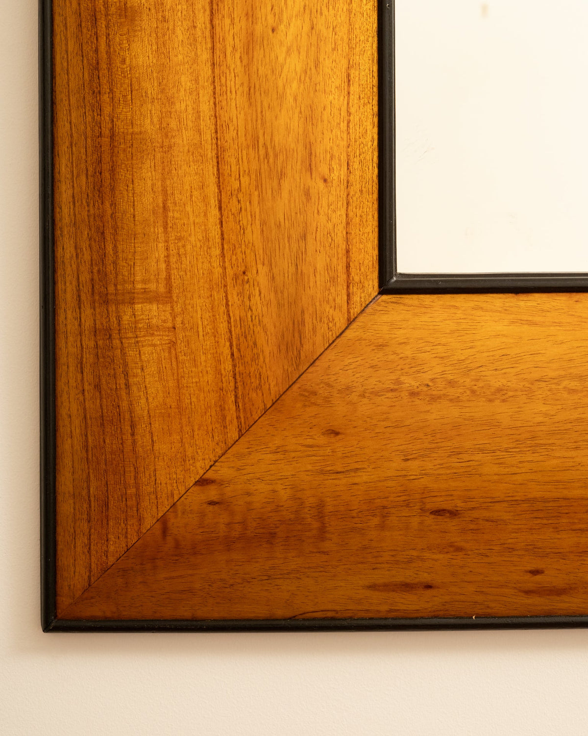 Corner detail of 1950s Italian wooden mirror frame with rich grain