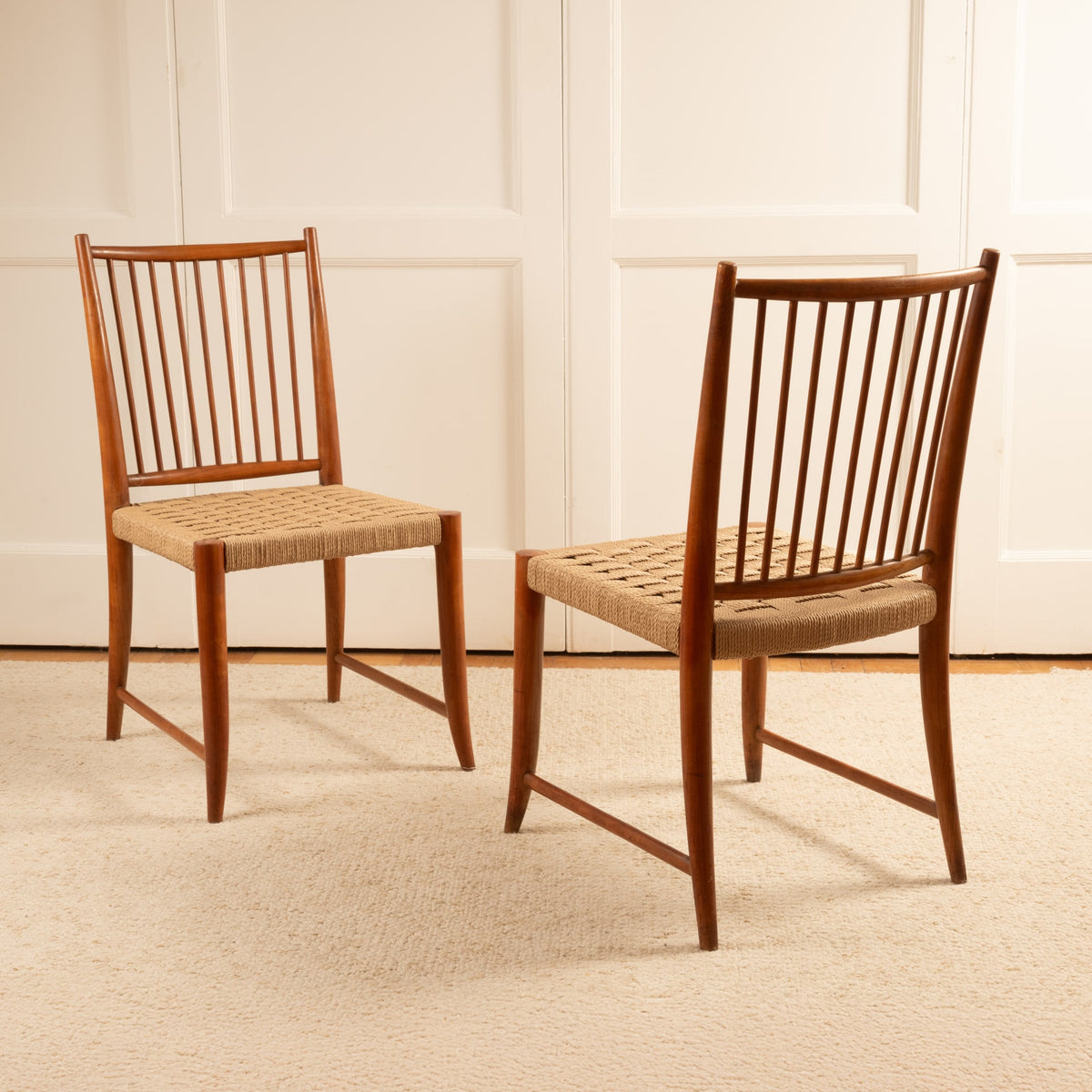 Two Paolo Buffa teak dining chairs with woven rush seats
