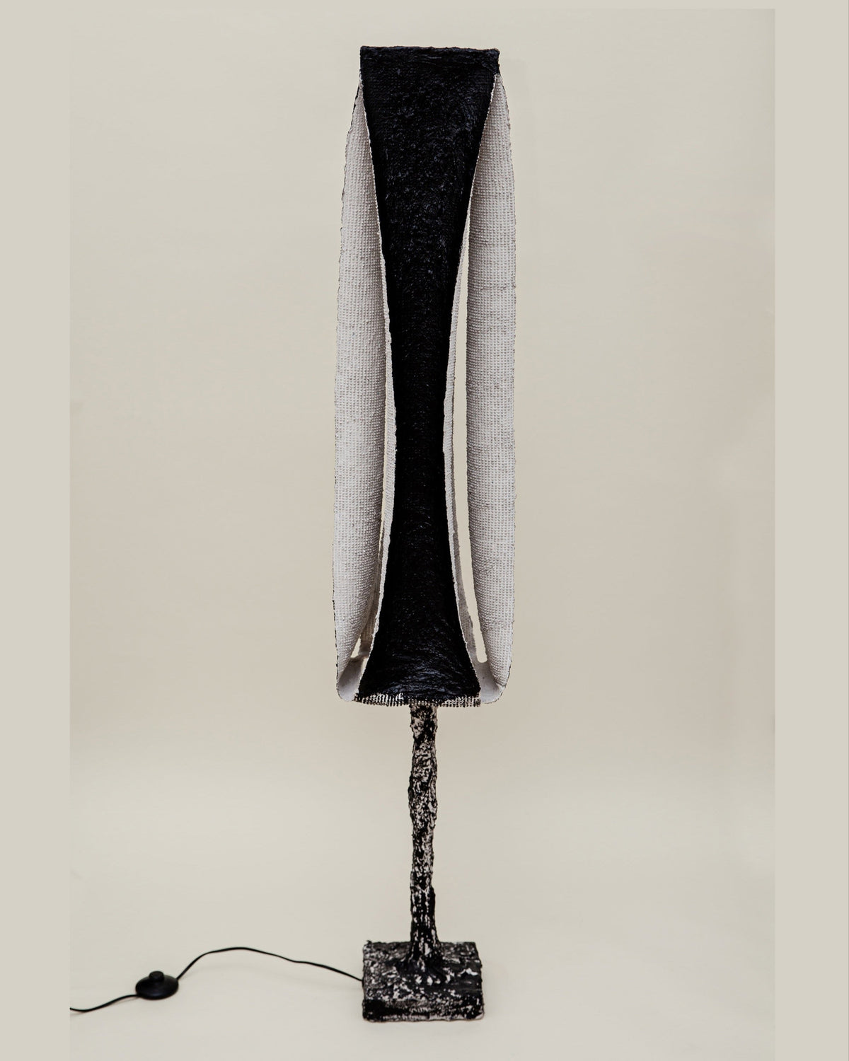 Rebirth I floor lamp with textured black shade and sculptural base