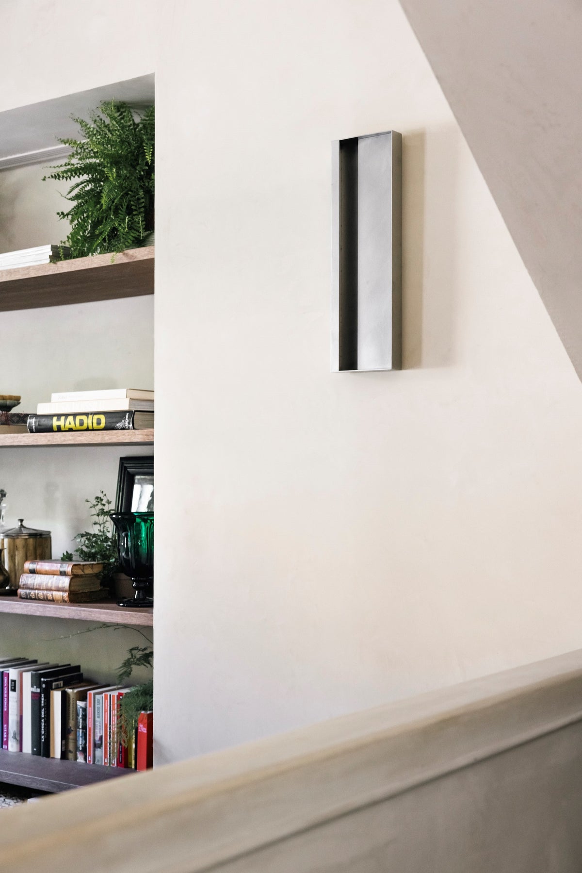 Julie Wall Lamp — mounted on wall beside bookshelf