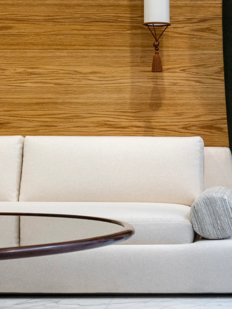 Podium Sofa (3-seater) — side angle with light fabric and wooden backdrop