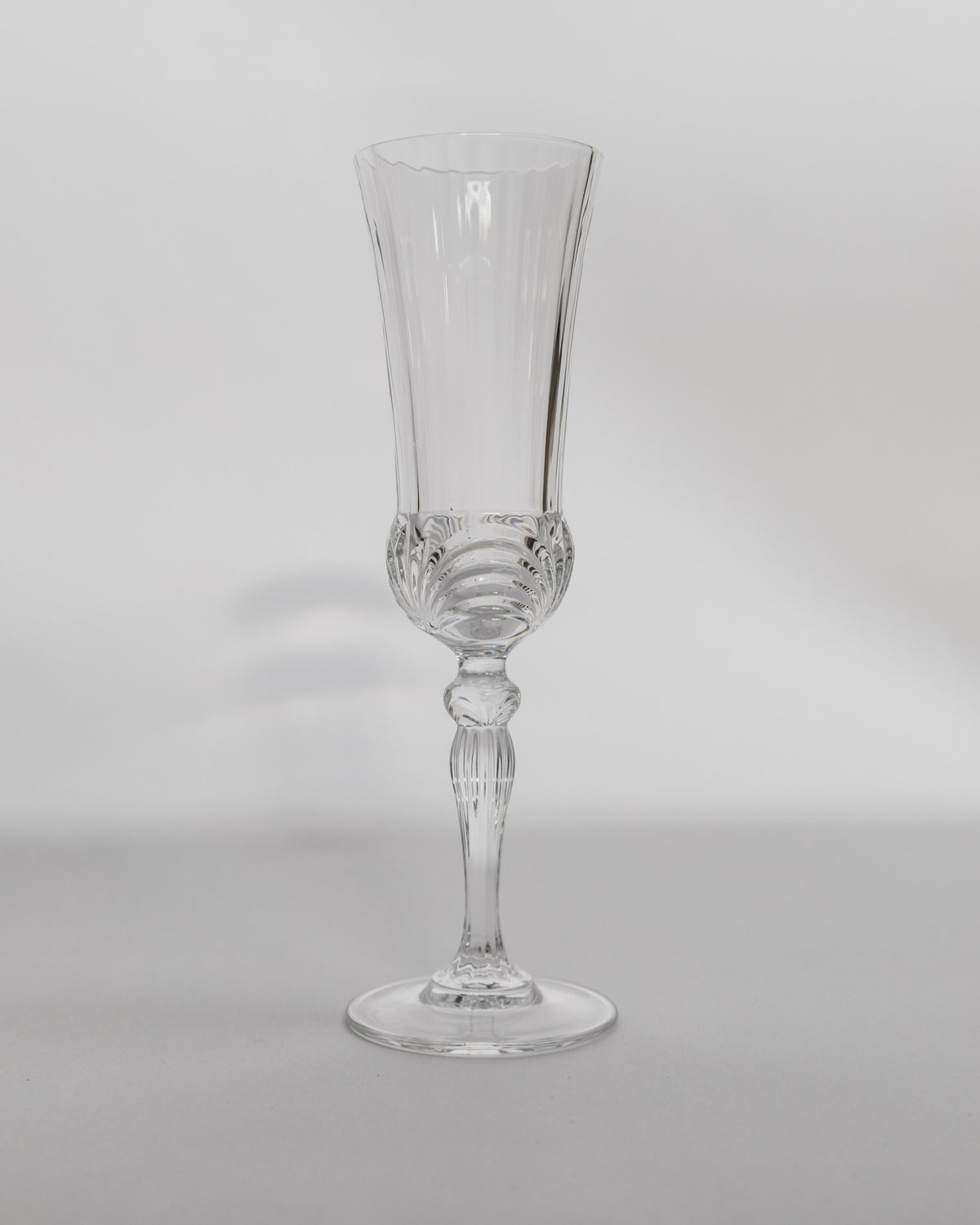 Crystal champagne flute with cut glass base and long stem detail