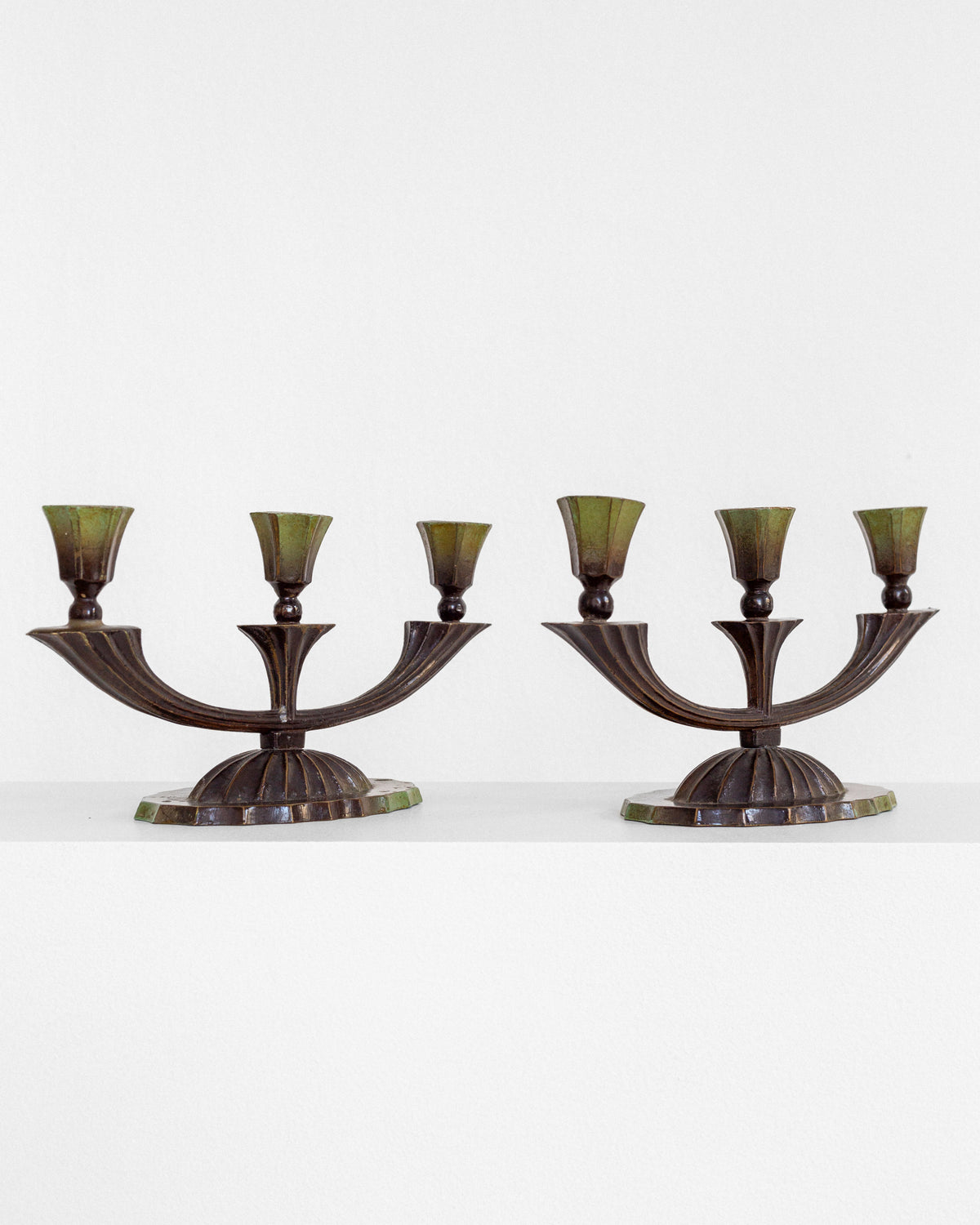 Pair of Art Deco bronze three-arm candelabras with green shades