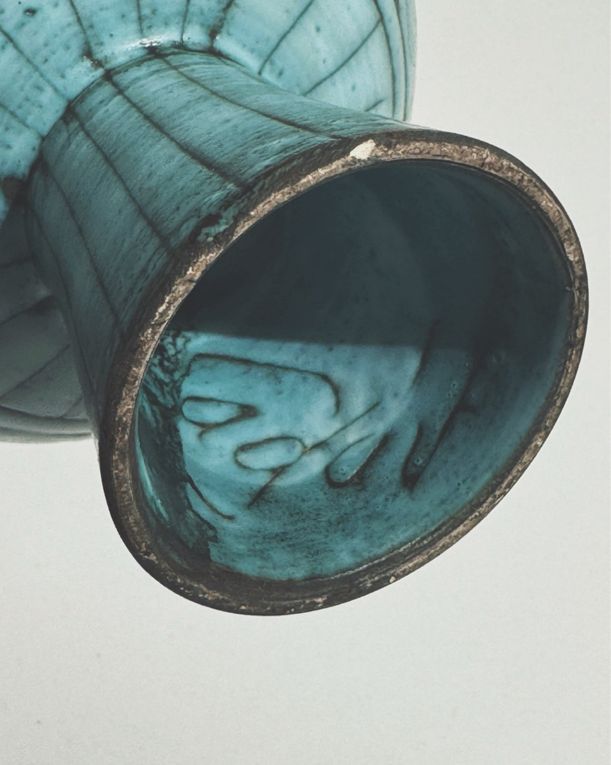 Turquoise ceramic bowl interior detail showing marbled glaze patterns