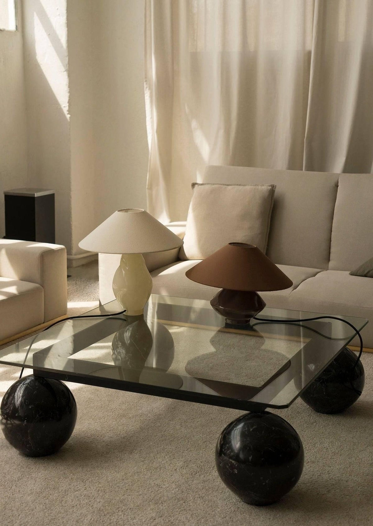 Beige conical glass table lamp styled on marble ball coffee table