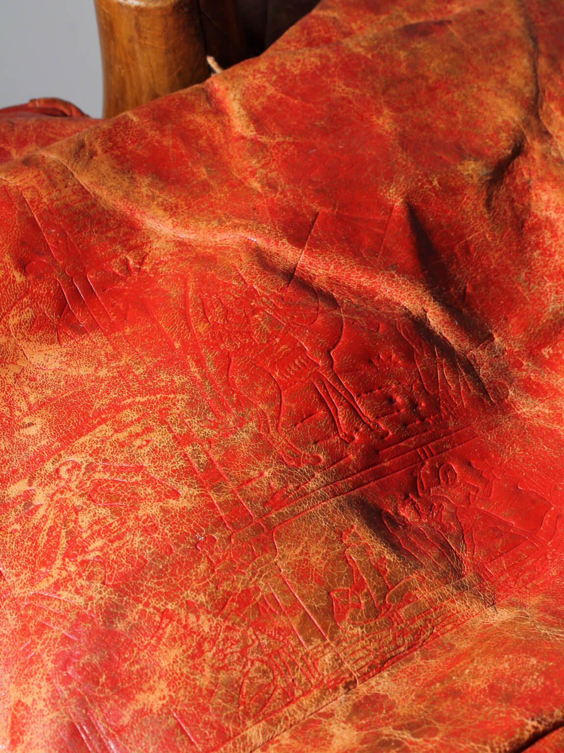 Egyptian Ottoman Camel Saddle Stool — close-up of red leather texture