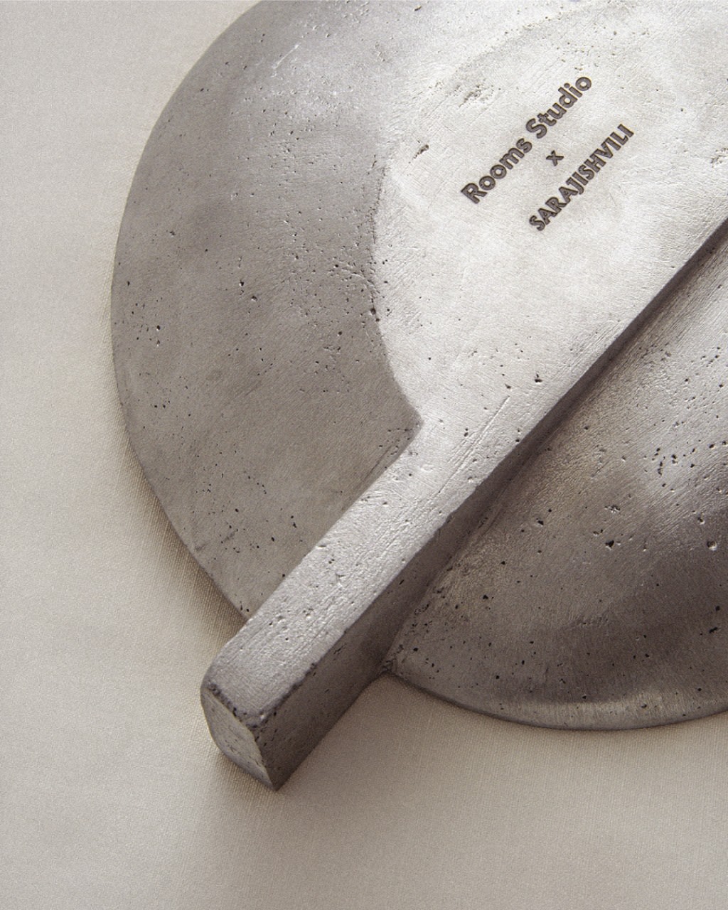 Aluminium Ashtray — side angle showing smooth concrete surface